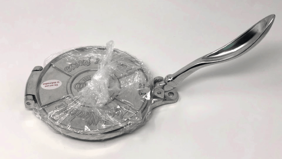 Wrapping your tortilla press with plastic wrap